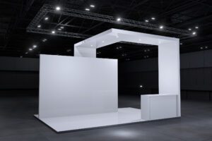 Minimalist white exhibition booth with clean lines and modern lighting.