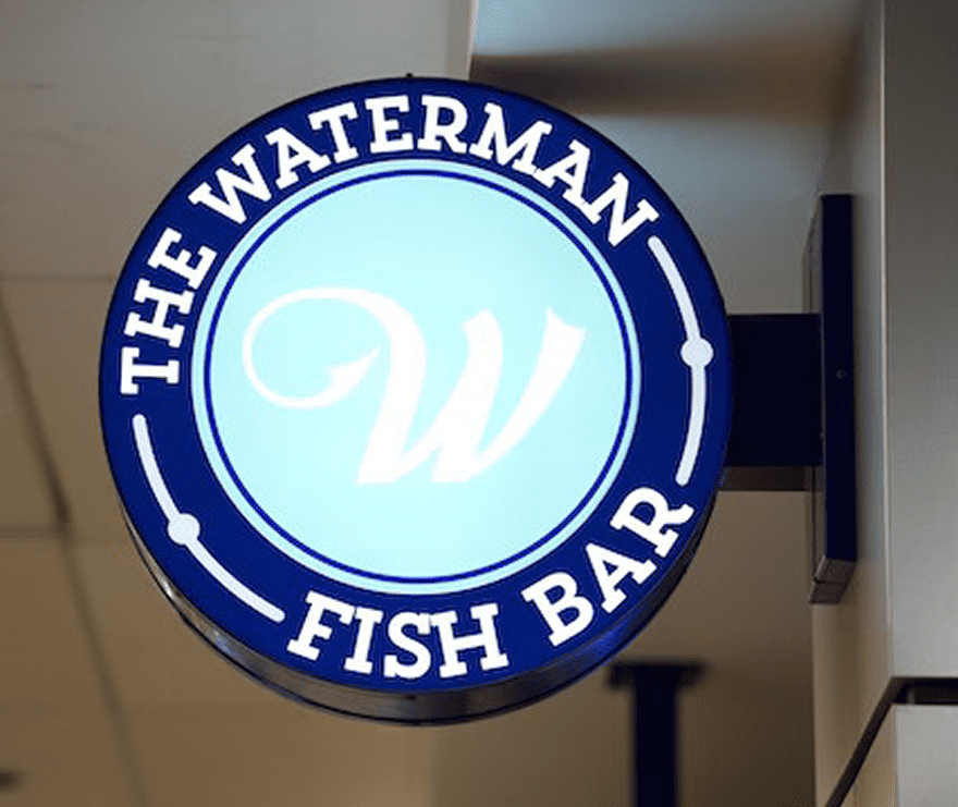 Illuminated round sign for The Waterman Fish Bar.