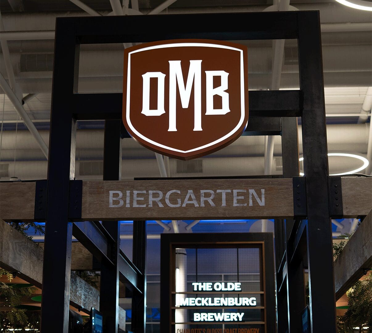 Brown shield OMB logo above Biergarten entrance